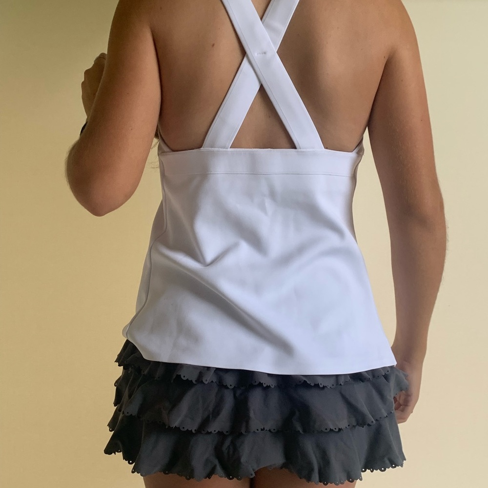 NB white top with navy blue piping. Size 4